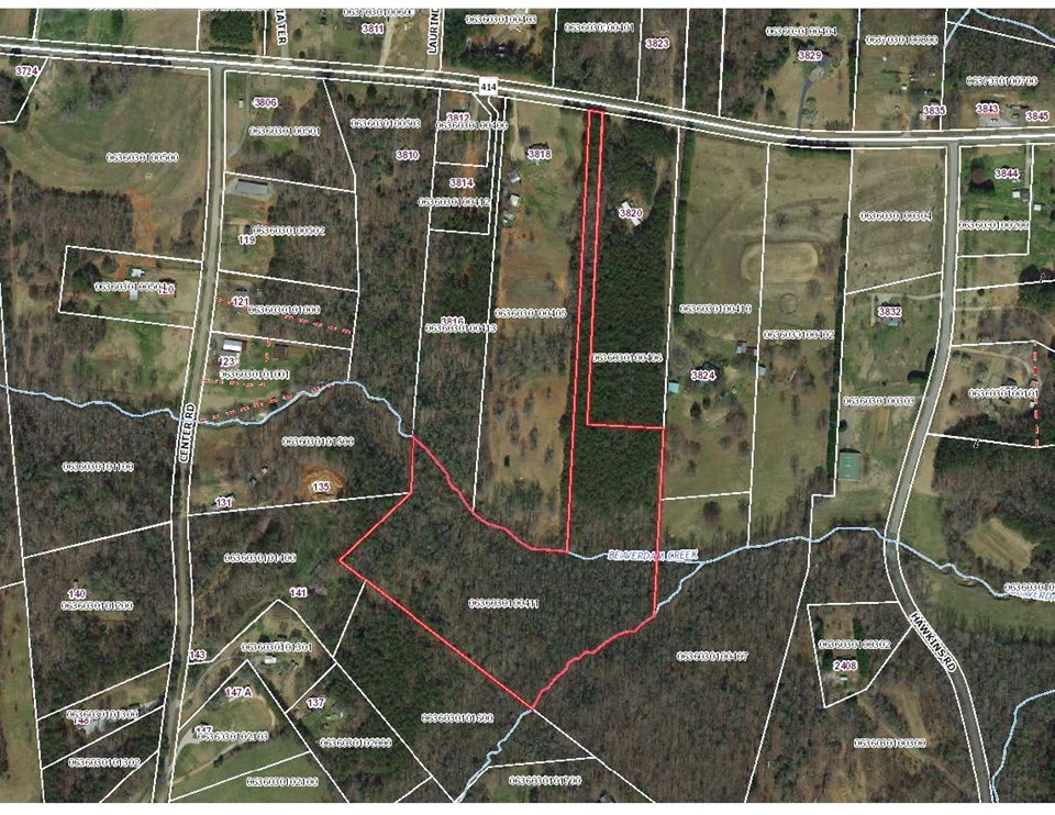 aerial view this aerial view shows the shape of the property from the highway all the way to the creeks.