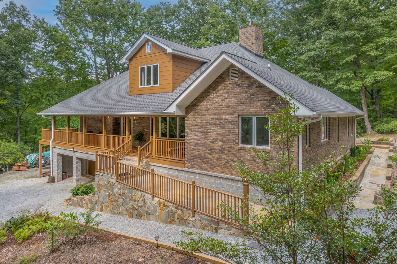 traditional brick faced home this home is completely brick veneer and all the windows are pella.  this view also takes in the right side of the home where the office and primary bedroom are located.  the dormer houses a skylight for the front entry foyer.  there is a stone ramp style walkway from the parking area off the circular drive.  roof is architectural shingle and about 6 years old.