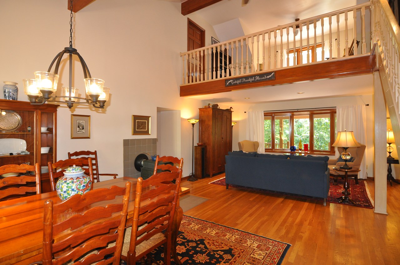 dining to living room and family room this view shows the view looking from the dining room to the front of the home.  the door in the family room goes to walk in attic storage.