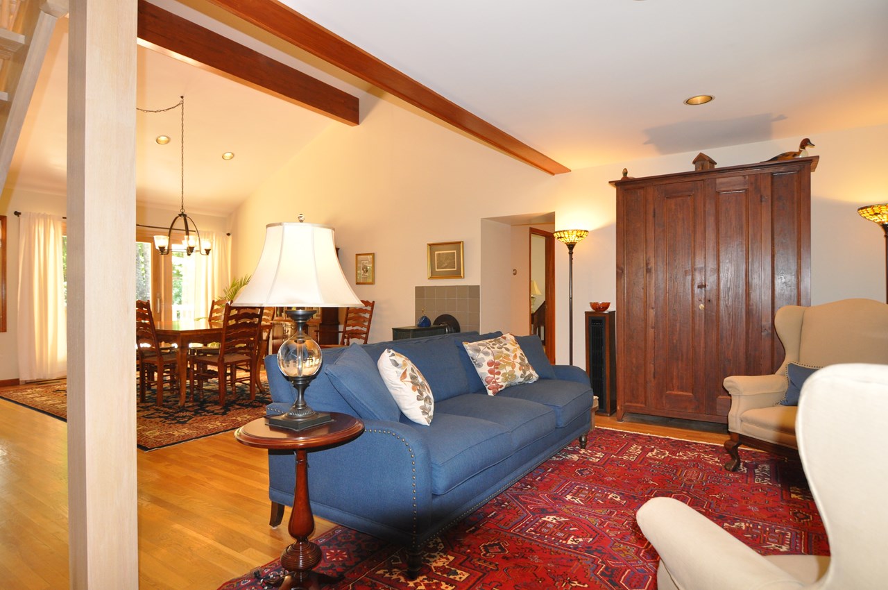 living room to dining the living room and dining area could easily be reversed to change the dynamic of the rooms.  the opening to the right is a hall to the primary bedroom, laundry and office.