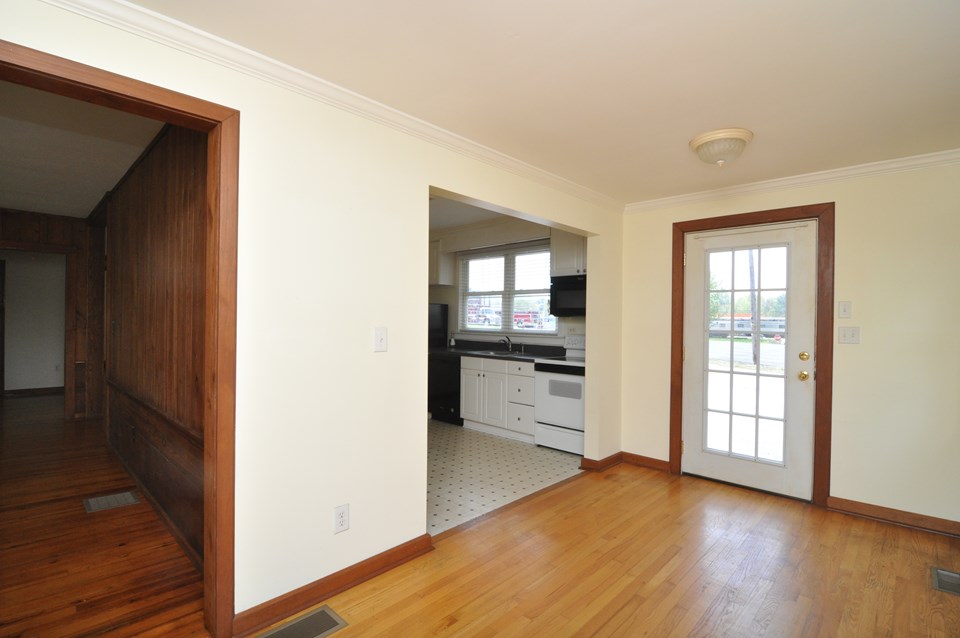 dining the dining room is 14.8x7.6 and has a hardwood floor. there is easy access to the living room and kitchen and the door goes out to the parking area.