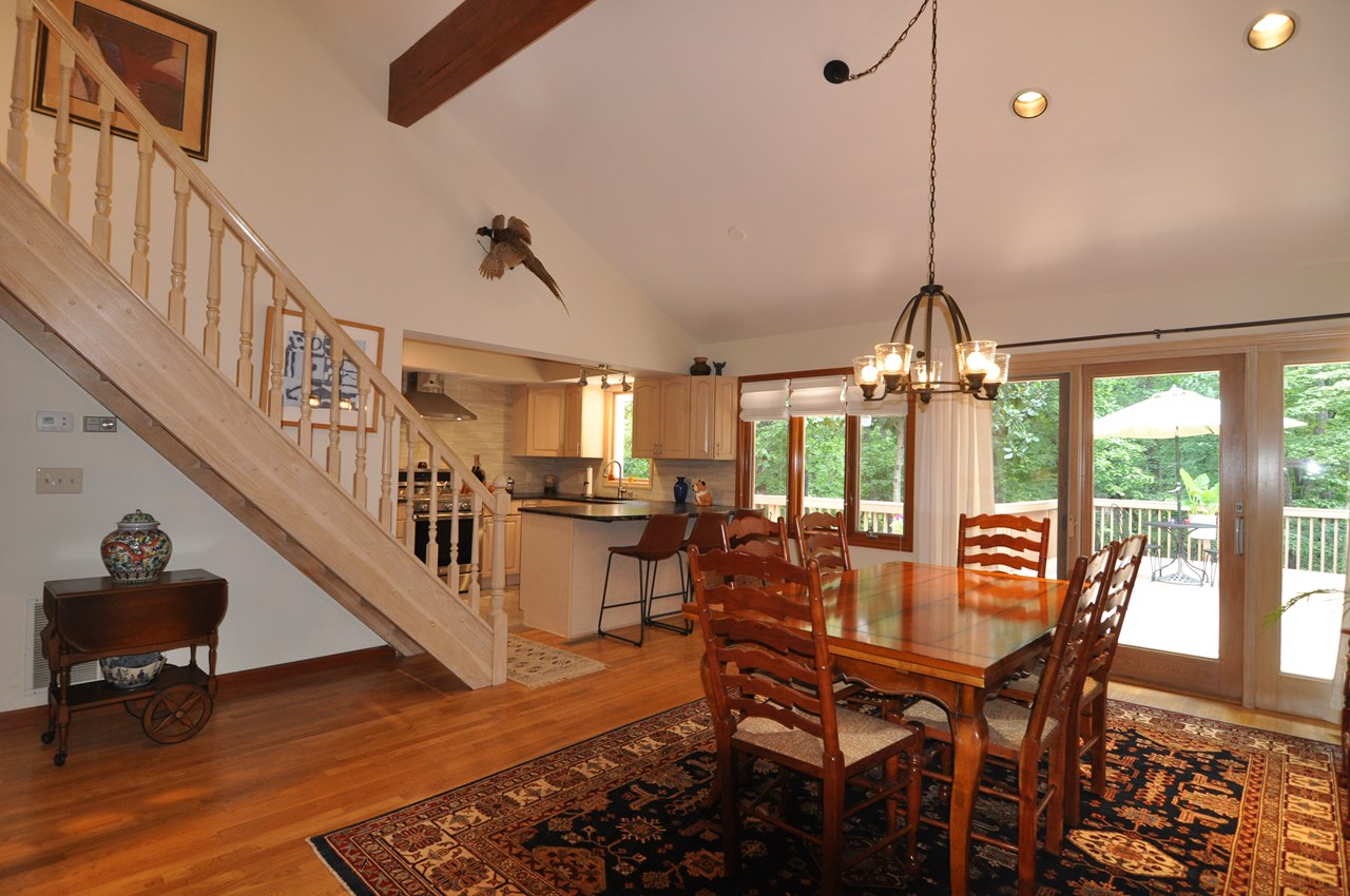 dining to kitchen and deck this view shows the kitchen as well as the stairs going to the family room. the sliding doors to the deck are pella.
