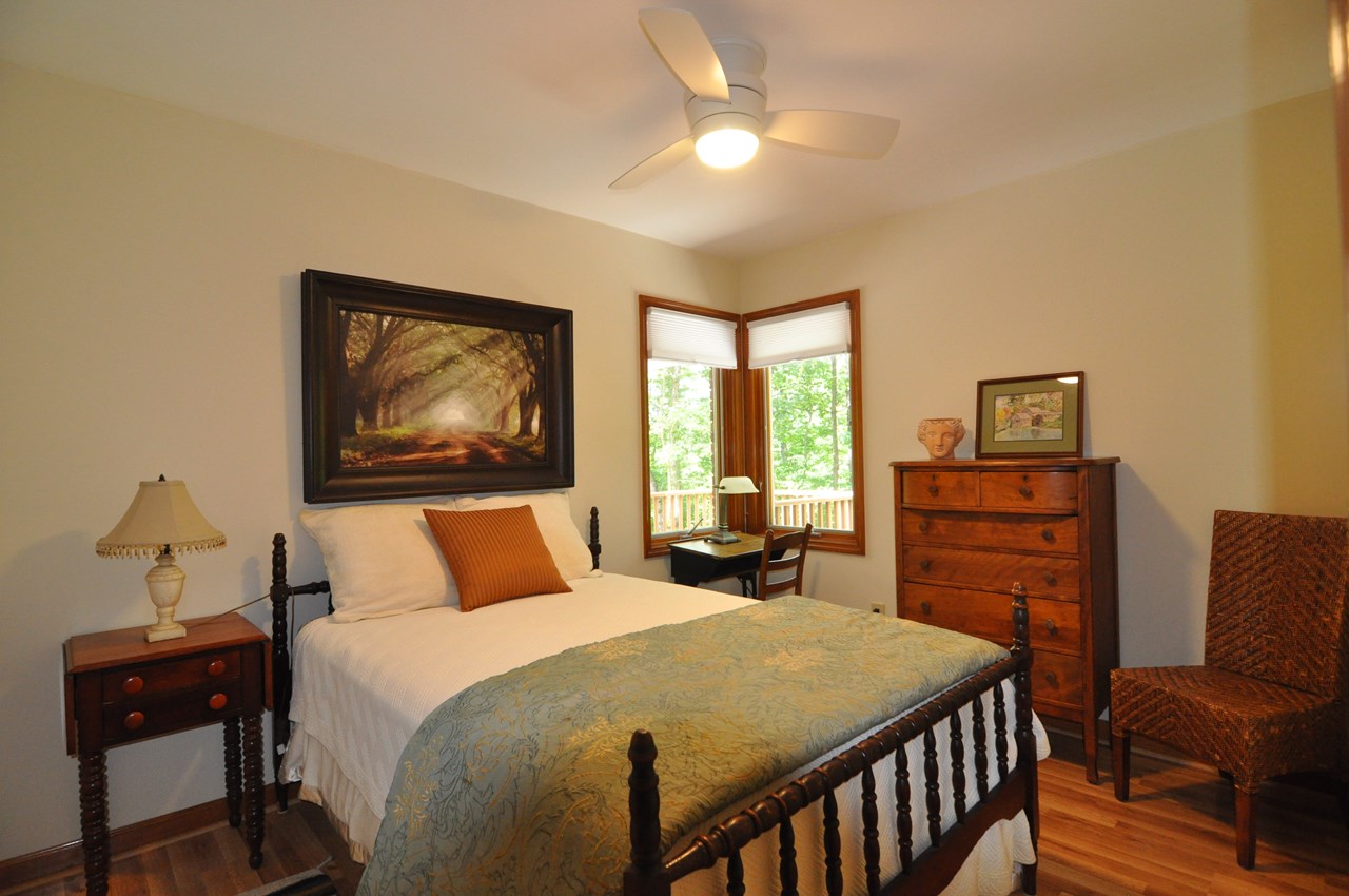front guest bedroom the front guest bedroom is 11 x 9 and has a ceiling fan and laminate floor. there is a full bath between it and the back guest bedroom that has a soaking tub with a shower that is tile. the bathroom floor is also tile.