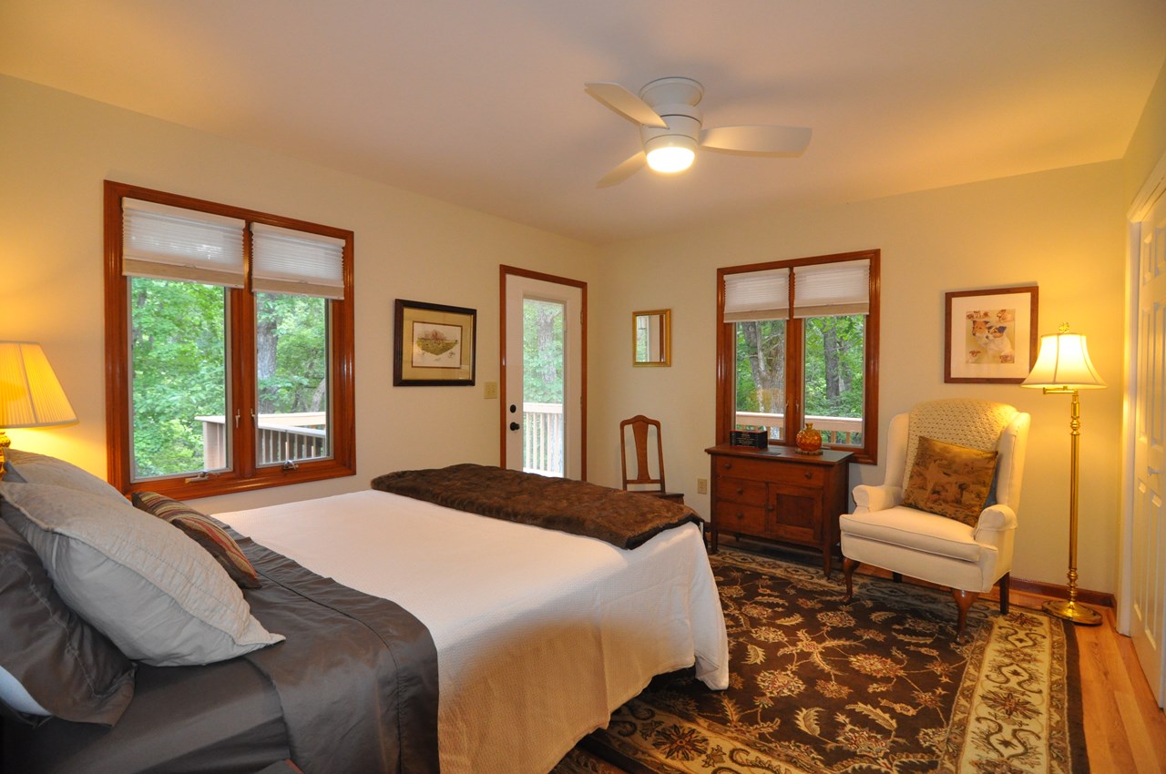 back guest bedroom the back guest bedroom is 13 x 11 and also has a laminate floor and a ceiling fan. the door goes out to a deck that ties in to the rest of the extensive decking at the back of the home.