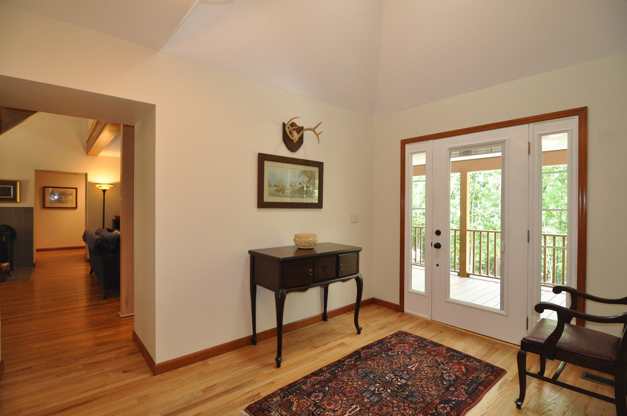 entry foyer the entry foyer is 8 x 12 and has a hardwood floor and skylight above. through the opening is the living and dining room.